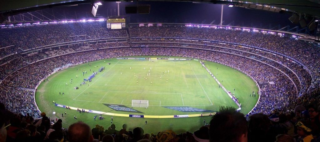 Panoramic image of the Melbourne Cricket Ground during a friendly international football game between Australia and Greece on 25 May 2006. By Charles Gregory (en:User:Chuq) (Own work) [GFDL (http://www.gnu.org/copyleft/fdl.html), CC-BY-SA-3.0 (http://creativecommons.org/licenses/by-sa/3.0/) or CC BY-SA 2.5-2.0-1.0 (http://creativecommons.org/licenses/by-sa/2.5-2.0-1.0)], via Wikimedia Commons