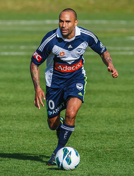 Archie Thompson playing in a pre-season game between the Central Coast Mariners and Melbourne Victory on 16/09/2012. By Camw (Own work) [CC BY-SA 3.0 (http://creativecommons.org/licenses/by-sa/3.0)], via Wikimedia Commons